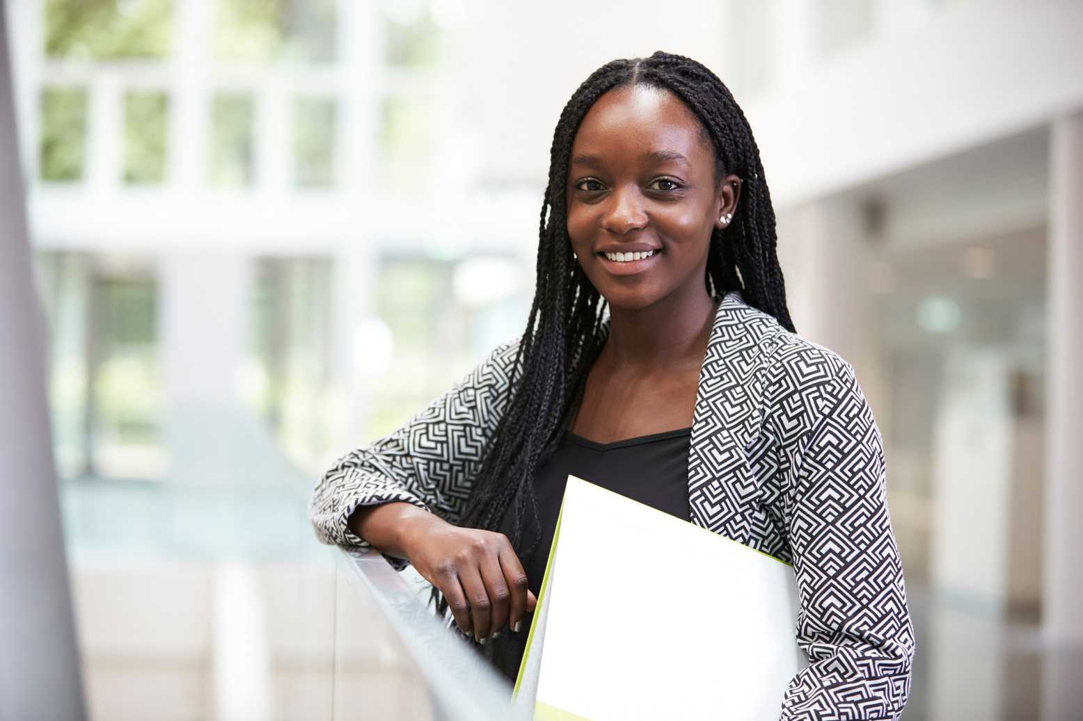 Smiling Young Black Female Student in University Foyer